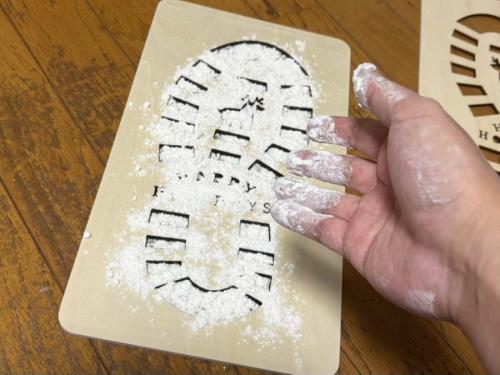 木板を床に置いて、小麦粉をさらさらっとふりかける